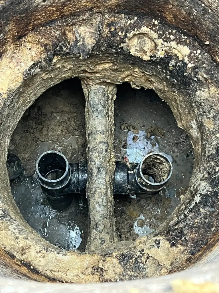broken baffle T inside grease interceptor showing internal damage in Los Angeles