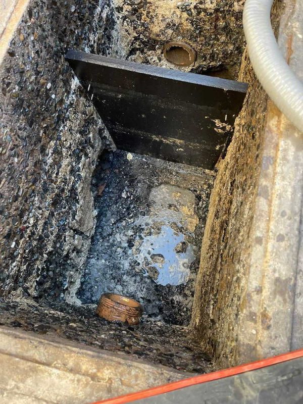 grease trap cleaning and maintenance operation in Los Angeles commercial kitchen removing grease buildup