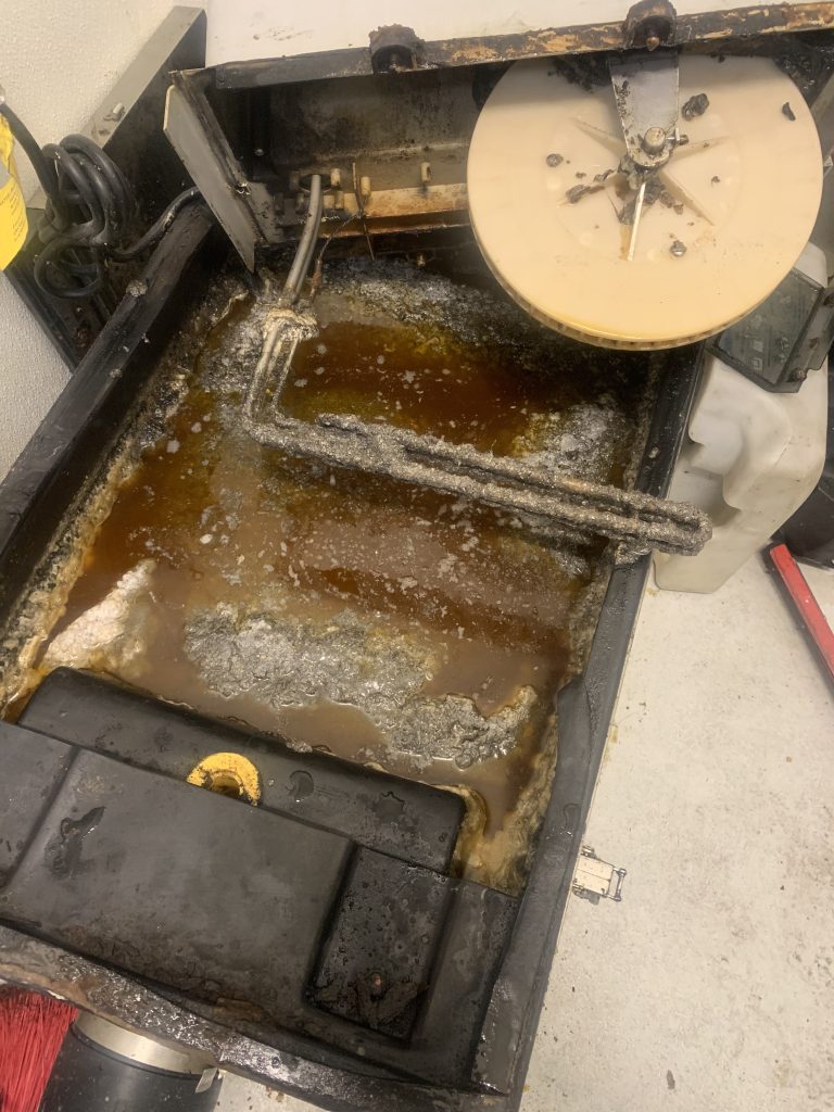 commercial grease trap repair for overflowing unit in Los Angeles kitchen removing excess grease and waste