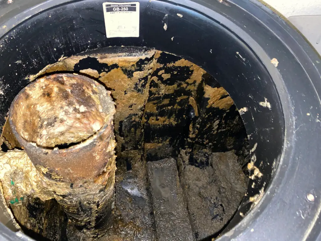 broken grease trap baffle inside unit requiring emergency grease trap baffle repair in Los Angeles kitchen